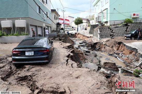 当地时间2018年9月6日，日本北海道地区发生强震，厚真町出现大规模塌方，多人被困。图为地震导致地面出现塌陷吞噬车辆。